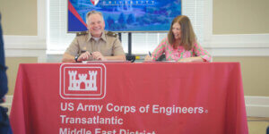 Commander of the U.S. Army Corps of Engineers Transatlantic Middle East District Col. Philip Secrist III and SU President Tracy Fitzsimmons sign a memorandum of understanding.