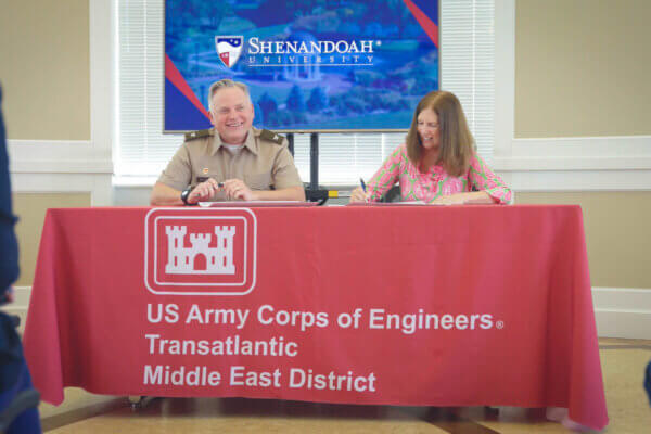 Commander of the U.S. Army Corps of Engineers Transatlantic Middle East District Col. Philip Secrist III and SU President Tracy Fitzsimmons sign a memorandum of understanding.