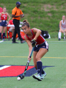 Shenandoah University field hockey player Elise Velasquez controls the ball during a game.