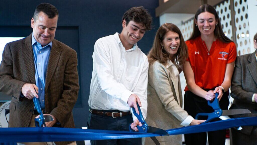 Individuals cut the ceremonial ribbon for the opening of Shenandoah University's Wilkins Health & Fitness Suite.