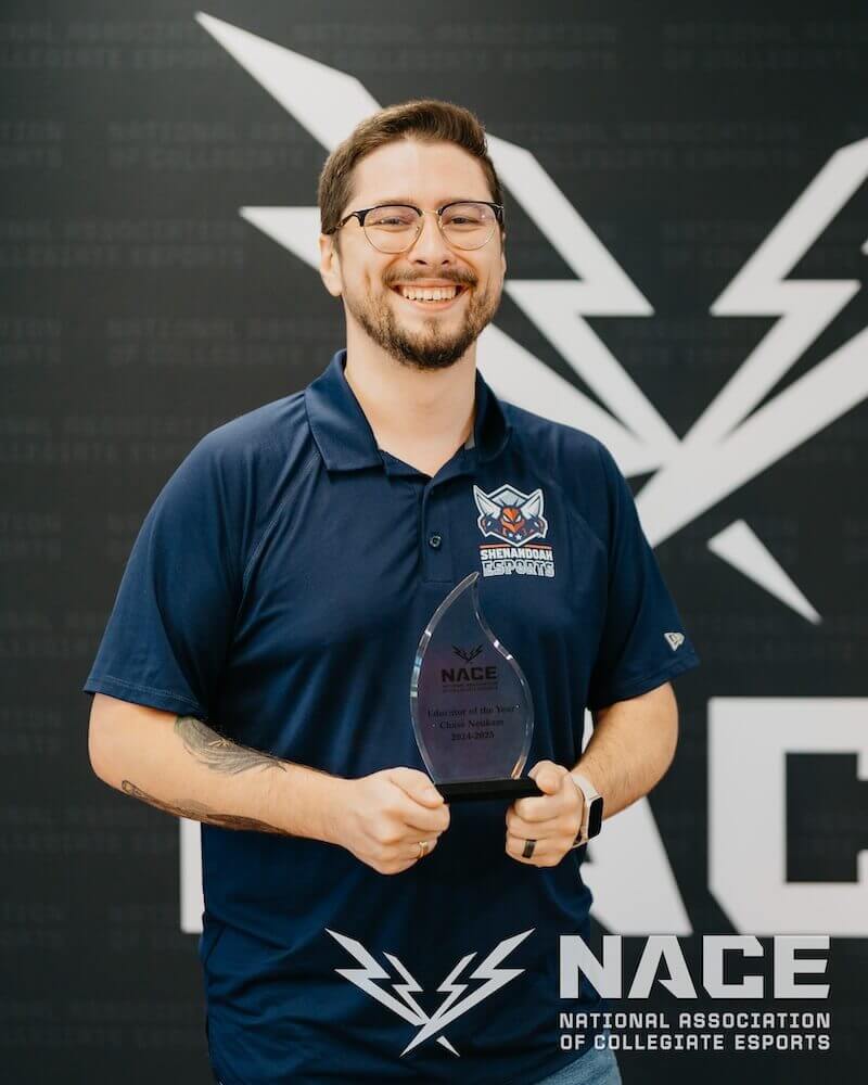 Shenandoah Esports Lecturer Chase Neukam holds his NACE Award for Educator of the Year.