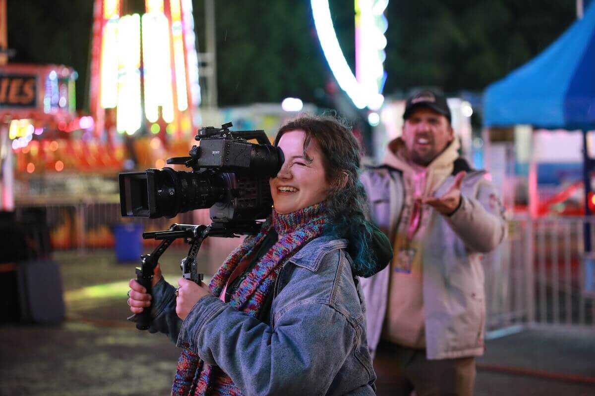 Shenandoah student Claire Turner operating a camera during a scene for "Miss Valentine" that was filmed at the Apple Blossom Festival carnival.