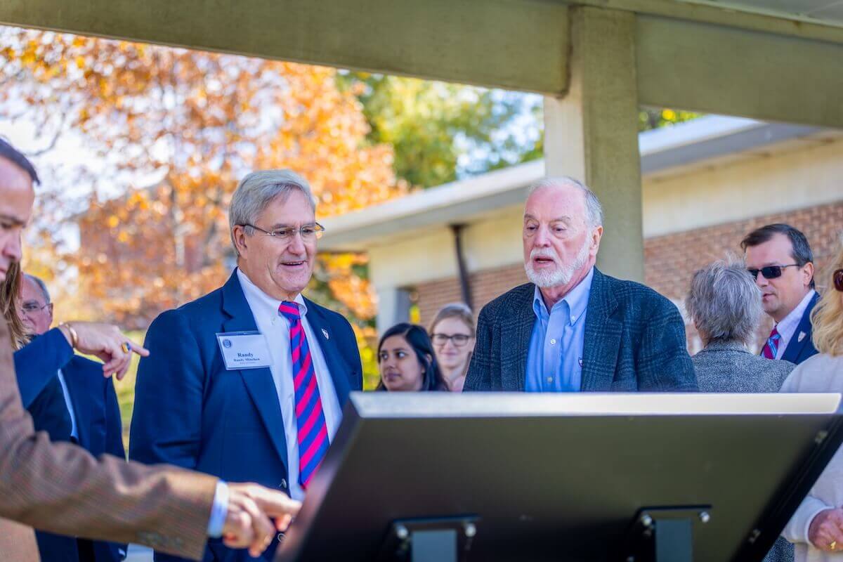 James R. "Jimmy" Wilkins, Jr. and Randy Minchew observe a new wayfinding sign.