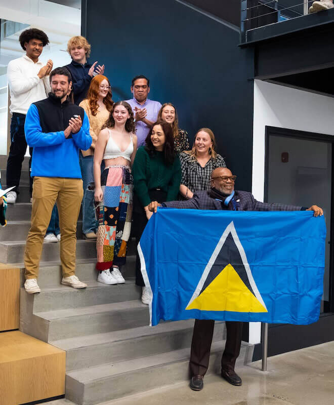 Shenandoah students, faculty and staff pose with the Saint Lucia flag.
