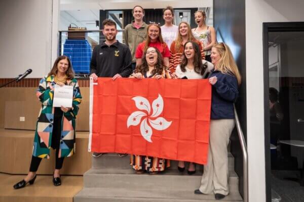 Shenandoah students, faculty and staff pose with the Hong Kong flag.