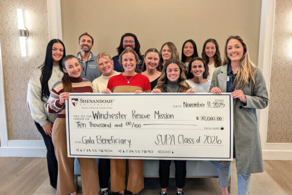 Shenandoah PA students present a check worth $10,000 to Winchester Rescue Mission CEO Lauren Clouse.
