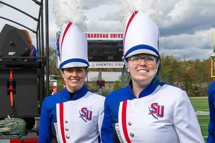 Emma Shields stands with a fellow percussionist at Shentel Stadium.