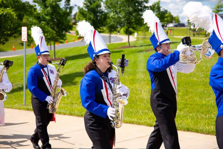 Izzy Miller marches in a parade with the rest of the marching band.