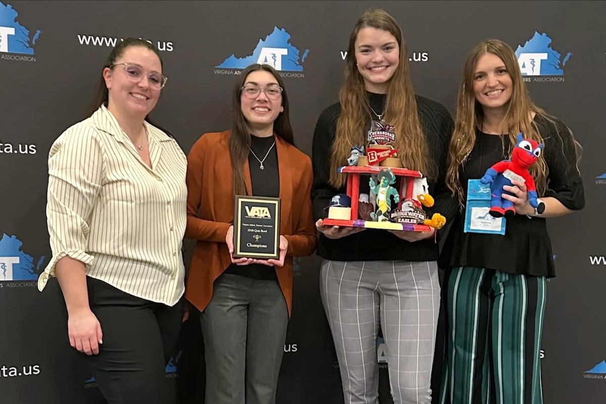 Students and a faculty member pose with the VATA Student Quiz Bowl trophy and plaque.