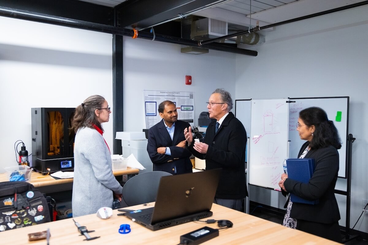 Andy Ferrari and Raj and Neeraja Lingam talk to Shenandoah University staff in the Makerspace.