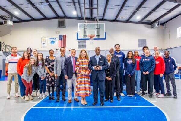 Group photo of individuals from Shenandoah University and Mount Carmel Baptist Church inside the church's Family Life Center.