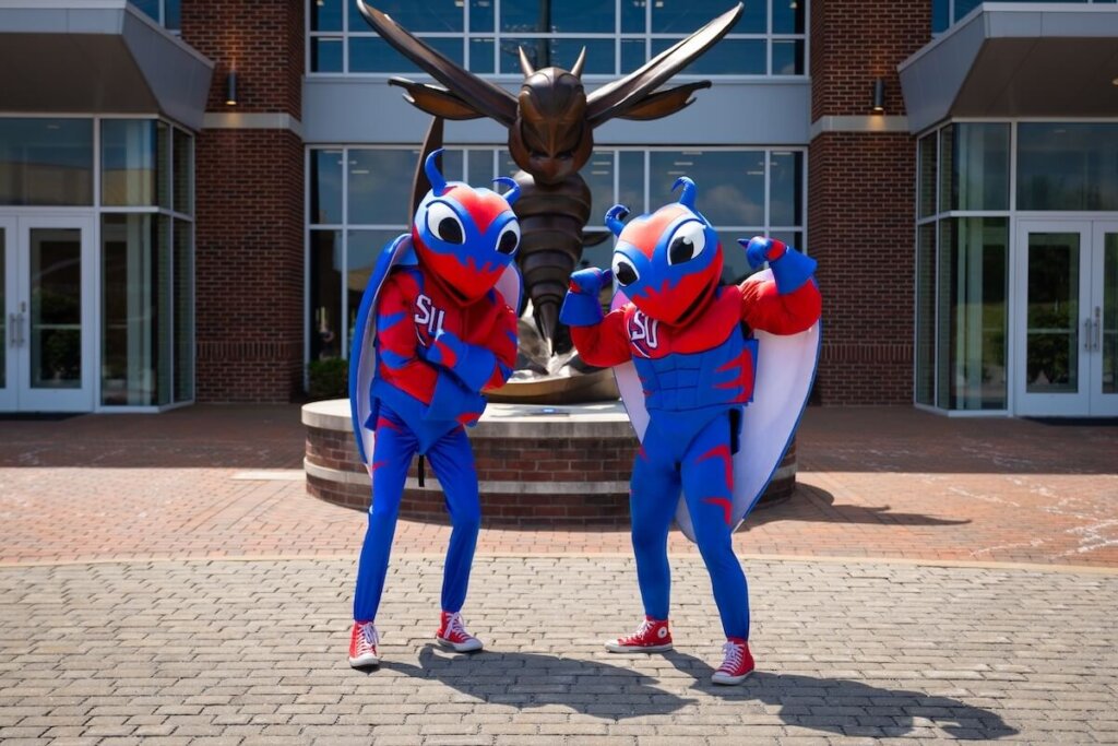 Two Shenandoah University students pose in the Buzzy mascot costumes.