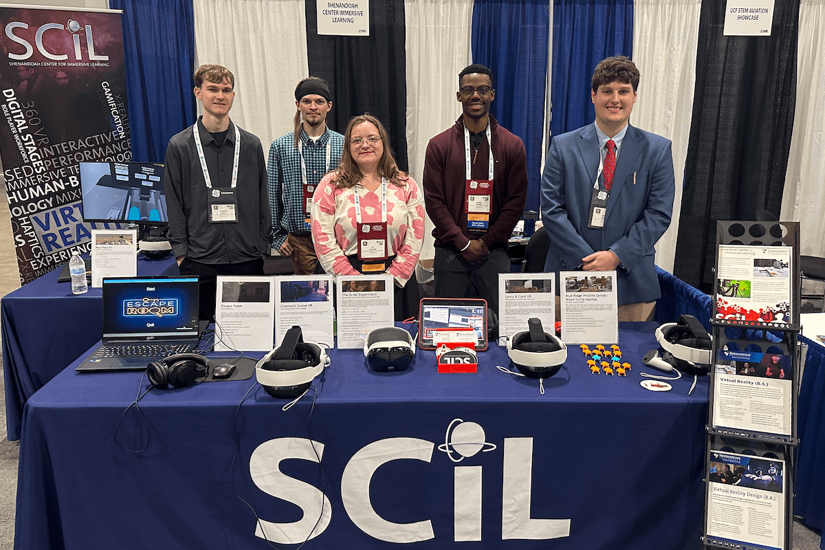 Students pose at a booth for the Shenandoah Center for Immersive Learning.