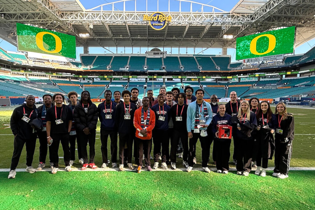 A group of Shenandoah students stand on the field at Hard Rock Stadium in Miami.