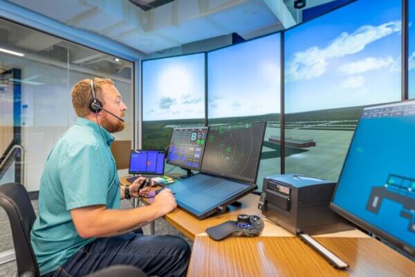 The director of aviation studies sits at a monitor in the air traffic control simulation lab.
