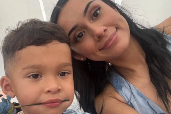LRCC Co-Enrolled student Sara Hernandez and little boy with a fake blue flower in his mouth.