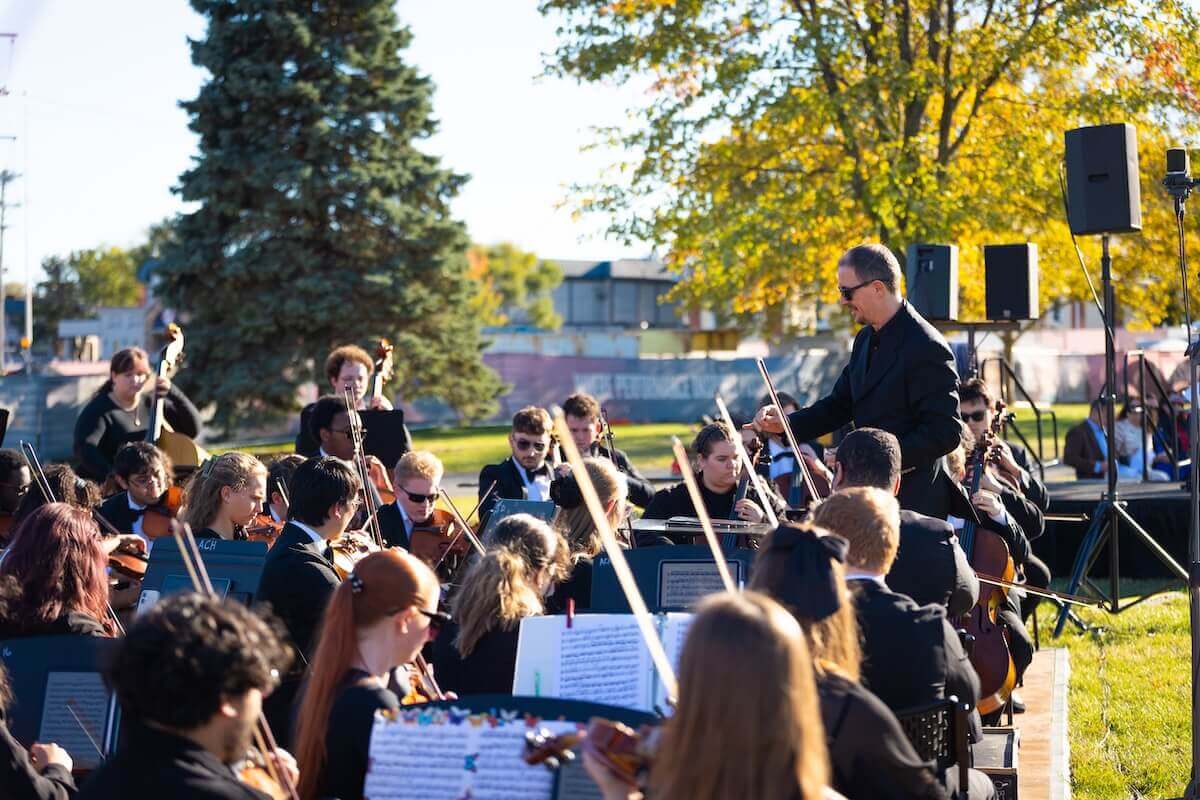 The Shenandoah Conservatory Symphony Orchestra performs outdoors.