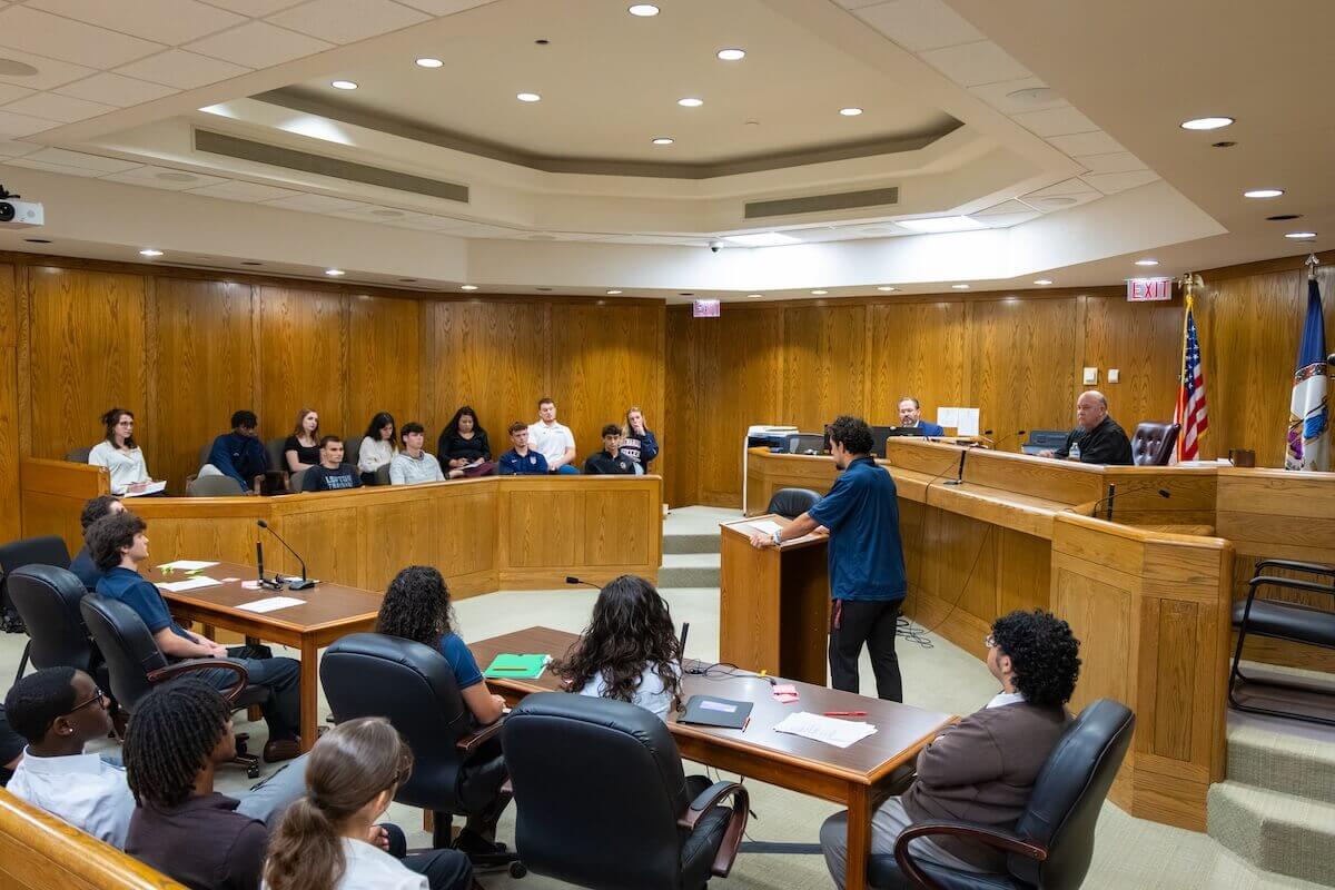 A wide shot of a courtroom where Shenandoah students are performing various roles in a mock trial scrimmage.