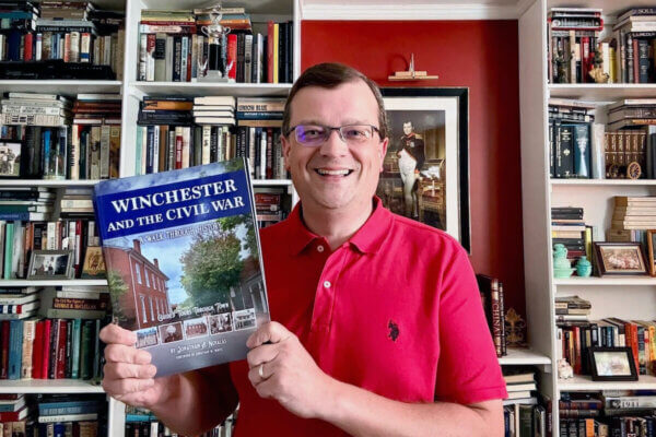 Shenandoah University professor Jonathan Noyalas holds a copy of his new book, "Winchester and the Civil War."