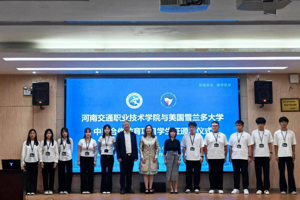 Students pose on stage for a group photograph.